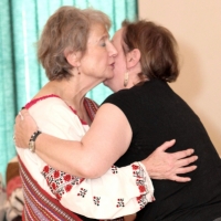 Myrna-Kostash-receives-sash-from-Sharon-Morin